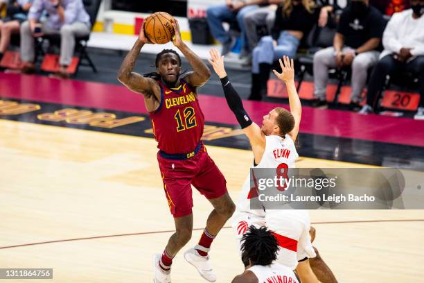 Taurean Prince of the Cleveland Cavaliers passes the ball over Malachi Flynn of the Toronto Raptors at Rocket Mortgage FieldHouse on April 10, 2021...