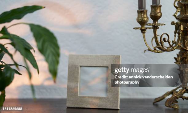 linen photo frame - photo frame on mantle piece stockfoto's en -beelden