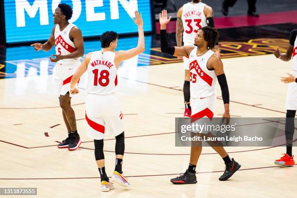 Yuta Watanabe of the Toronto Raptors high fives Delon Wright of the Toronto Raptors at Rocket Mortgage FieldHouse on April 10, 2021 in Cleveland,...