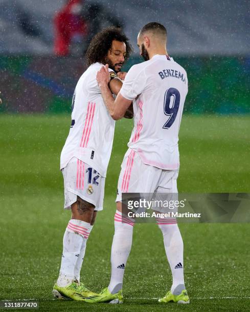 Karim Benzema of Real Madrid puts the captains armband on Marcelo during the La Liga Santander match between Real Madrid and FC Barcelona at Estadio...
