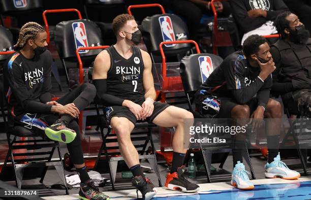 Nicolas Claxton,Blake Griffin and Jeff Green of the Brooklyn Nets react to the loss as they sit on the bench in the final minutes of the game against...