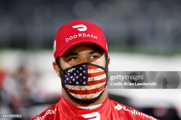 Bubba Wallace, driver of the DoorDash Toyota, waits on the grid prior to the NASCAR Cup Series Blue-Emu Maximum Pain Relief 500 at Martinsville...
