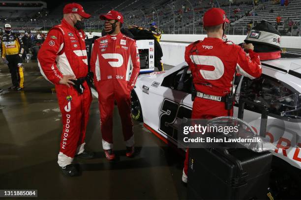 Bubba Wallace, driver of the DoorDash Toyota, and crew talk on the grid prior to the NASCAR Cup Series Blue-Emu Maximum Pain Relief 500 at...