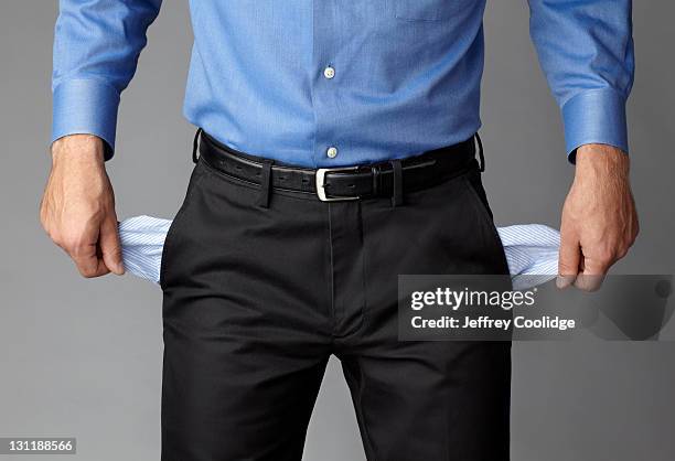 businessman with pockets pulled out - empty pockets stock pictures, royalty-free photos & images