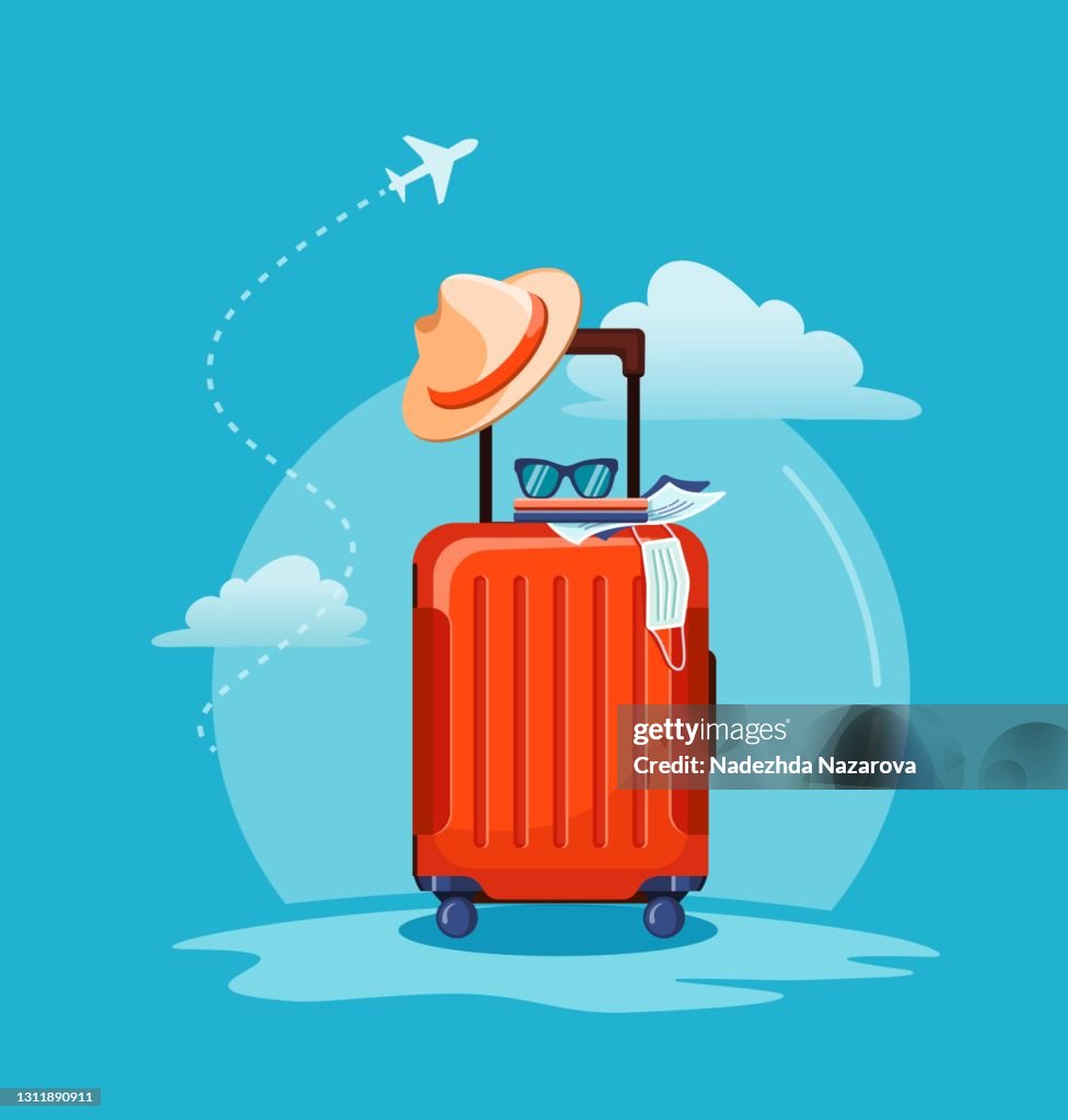 Airplane flying above tourists luggage: suitcase, passport, tickets, medical mask and sunglasses.