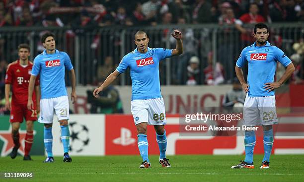 Federico Fernandez, Goekhan Inler and Blerim Dzemaili of Napoli react after Bayern Muenchen's second goal during the UEFA Champions League Group A...