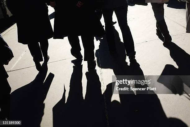 Businessmen and shoppers walk along Madison Avenue, one of Manhattan's premier shopping and residential streets on November 1, 2011 in New York City....