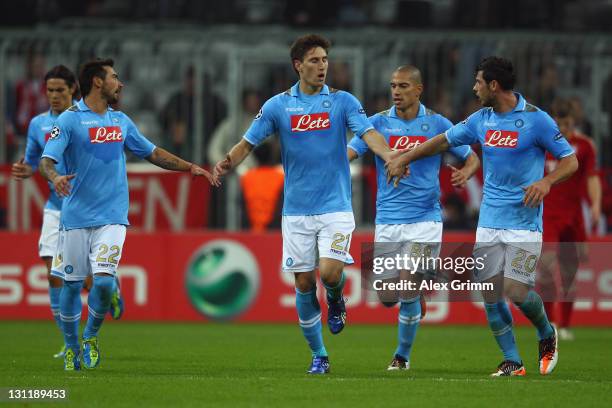 Federico Fernandez of Napoli celebrates his team's first goal with team mates during the UEFA Champions League group A match between FC Bayern...