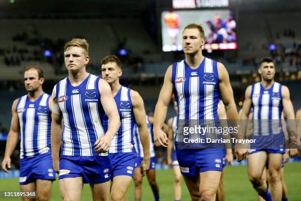 Dejected North Melbourne players walk from the ground after the round four AFL match between the North Melbourne Kangaroos and the Adelaide Crows at...