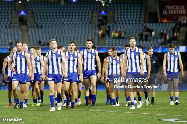 Dejected North Melbourne players walk from the ground after the round four AFL match between the North Melbourne Kangaroos and the Adelaide Crows at...
