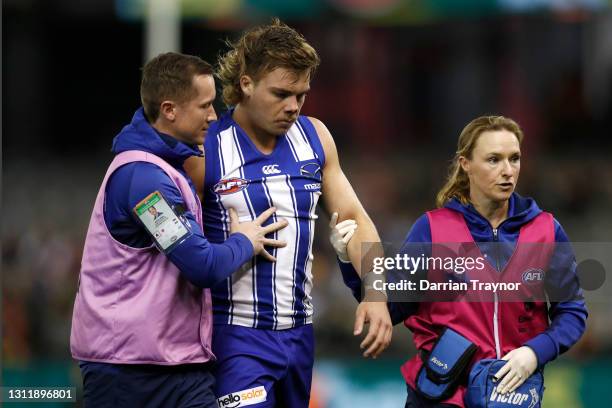 Cameron Zurhaar of the Kangaroos is helped by medical staff during the round four AFL match between the North Melbourne Kangaroos and the Adelaide...