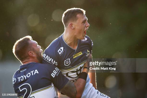 Scott Drinkwater of the Cowboys celebrates with team mates after scoring a try during the round five NRL match between the Wests Tigers and the North...