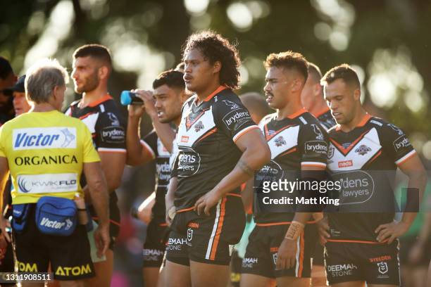 Wests Tigers players look dejected after a Cowboys try during the round five NRL match between the Wests Tigers and the North Queensland Cowboys at...