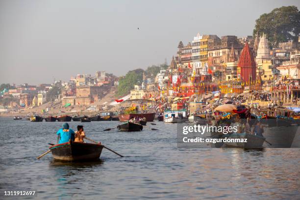 boats moored in front of ghats on the river ganges, varanasi, uttar pradesh, india - ghat stock pictures, royalty-free photos & images
