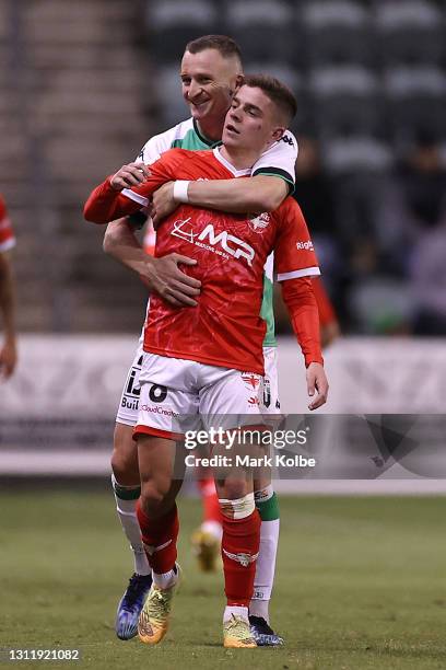 Besart Berisha of Western United embraces Cameron Devlin of the Phoenix during the A-League match between the Wellington Phoenix and Western United...