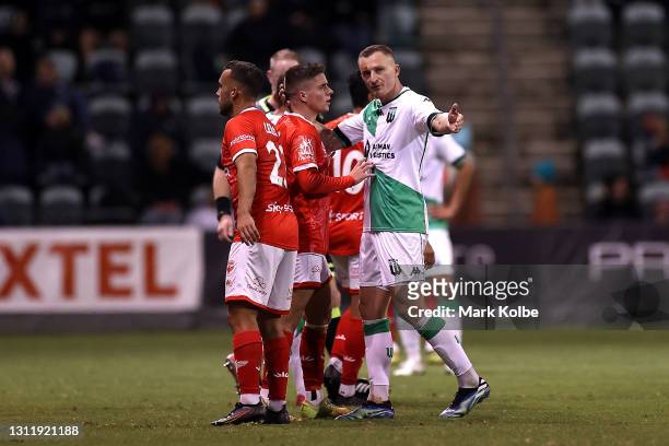 Besart Berisha of Western United embraces Cameron Devlin of the Phoenix during the A-League match between the Wellington Phoenix and Western United...