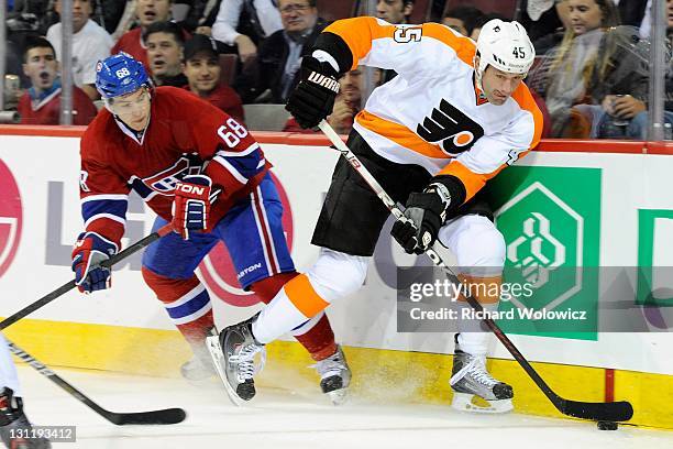 Jody Shelley of the Philadelphia Flyers skates with the puck while being defended by Yannick Weber of the Montreal Canadiens during the NHL game at...