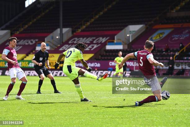 Allan Saint-Maximin of Newcastle United scores their team's second goal past James Tarkowski of Burnley during the Premier League match between...