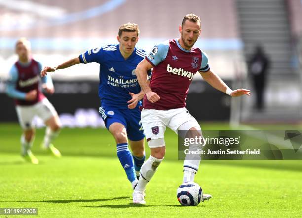 Vladimir Coufal of West Ham United makes a pass whilst under pressure from Dennis Praet of Leicester City during the Premier League match between...