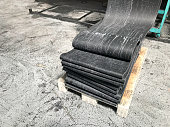 sliced rubber plates stacked on pallets