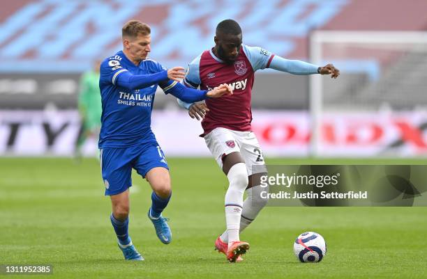 Arthur Masuaku of West Ham United battles for possession with Marc Albrighton of Leicester City during the Premier League match between West Ham...