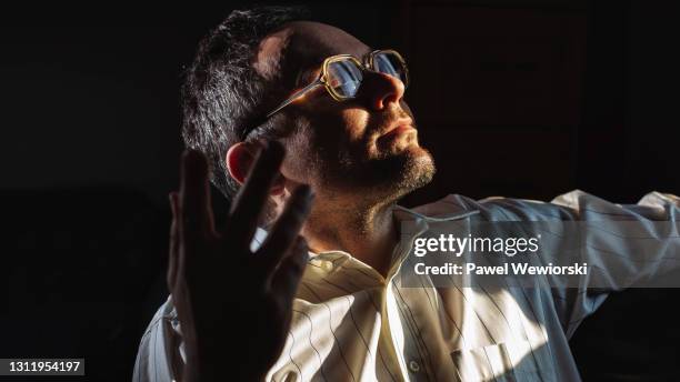 man enjoying sunlight - spiritual enlightenment stock pictures, royalty-free photos & images