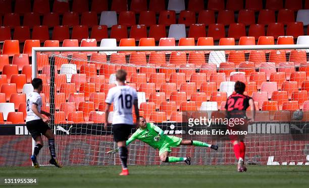 Alex Remiro of Real Sociedad looks on as Carlos Soler of Valencia CF takes a penalty and misses during the La Liga Santander match between Valencia...