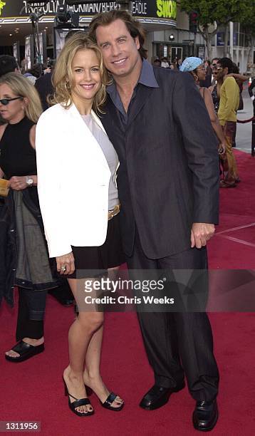 John Travolta and his wife, Kelly Preston, arrive at the world premiere of Warner Bros.'' "Swordfish" June 4, 2001 at the Mann Village Theatre in...