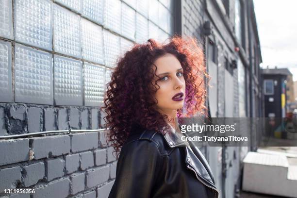 fashion teenager girl with curly hair and purple lips posing - latvia girls stock pictures, royalty-free photos & images