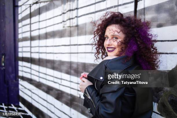 fashion teenager girl with curly hair and purple lips smiling - latvia girls stock pictures, royalty-free photos & images