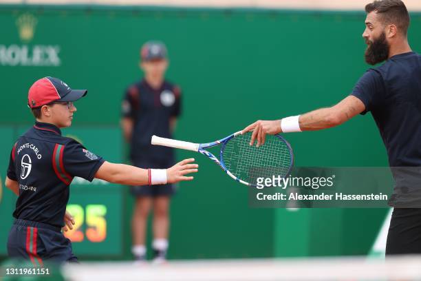 Benoit Paire of France hands over his Tennis Racket to a ball boy during his 1st round match against Jordan Thompson of Australia on Day 2 of the...