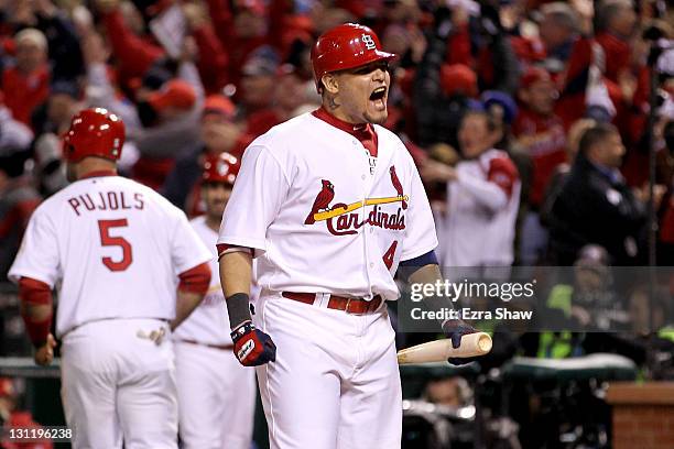 Yadier Molina of the St. Louis Cardinals celebrates after a two-run RBI triple by David Freese in the ninth inning during Game Six of the MLB World...