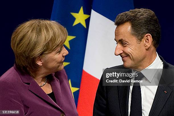 German Chancellor Angela Merkel and French President Nicolas Sarkozy are seen as they arrive for a press conference after a meeting with Greek Prime...