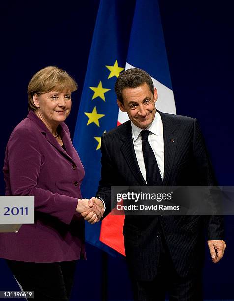 German Chancellor Angela Merkel and French President Nicolas Sarkozy shake hands at the end of a press conference after a meeting with Greek Prime...