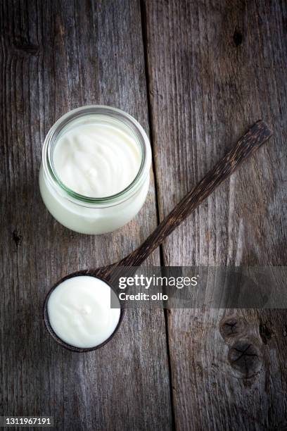 yoghurt pot, wooden table background - yogurt container stock pictures, royalty-free photos & images