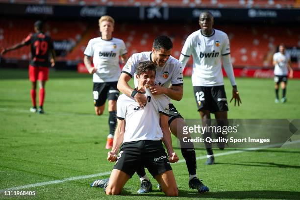 Gabriel Paulista of Valencia CF celebrates after scoring his team's second goal with his teammate Maxi Gomez during the La Liga Santander match...