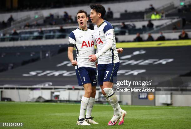 Son Heung-Min of Tottenham Hotspur celebrates with teammate Sergio Reguilon after scoring his team's first goal during the Premier League match...