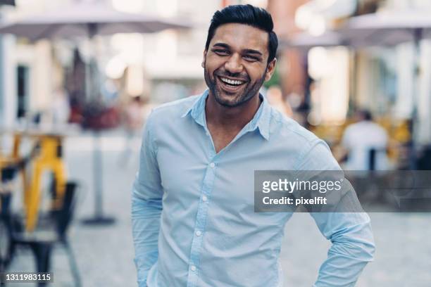 middle-eastern ethnicity man walking n the street - business man laughing stock pictures, royalty-free photos & images