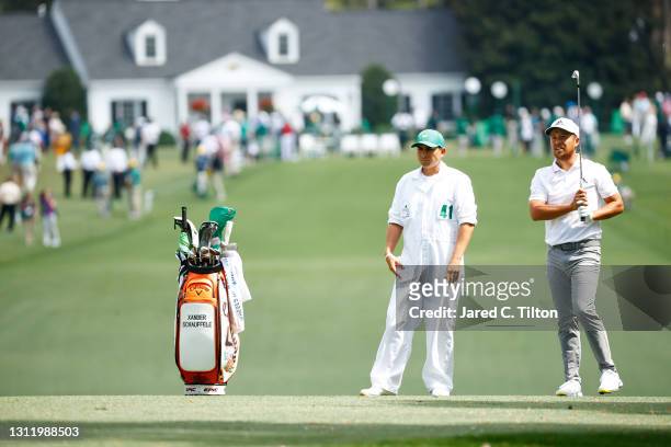 Xander Schauffele of the United States talks with his caddie, Austin Kaiser, on the first hole during the final round of the Masters at Augusta...