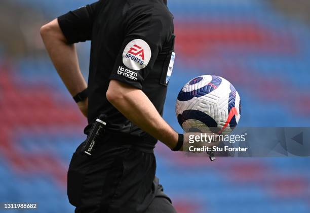 Detail picture of the Nike matchball and EA Sports and No Room For Racism logo's on the shirt of referee Anthony Taylor during the Premier League...