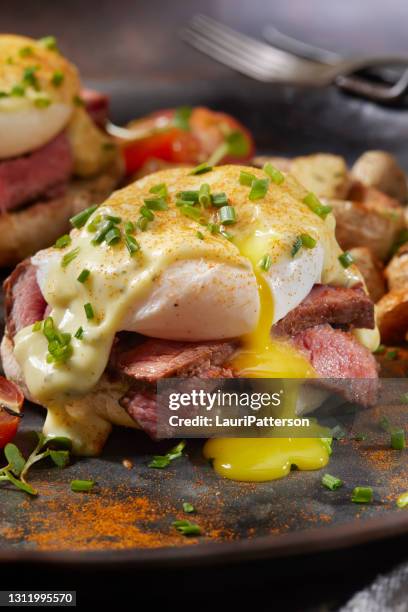 medium rare steak benedict on toasted english muffin - eggs benedict stock pictures, royalty-free photos & images