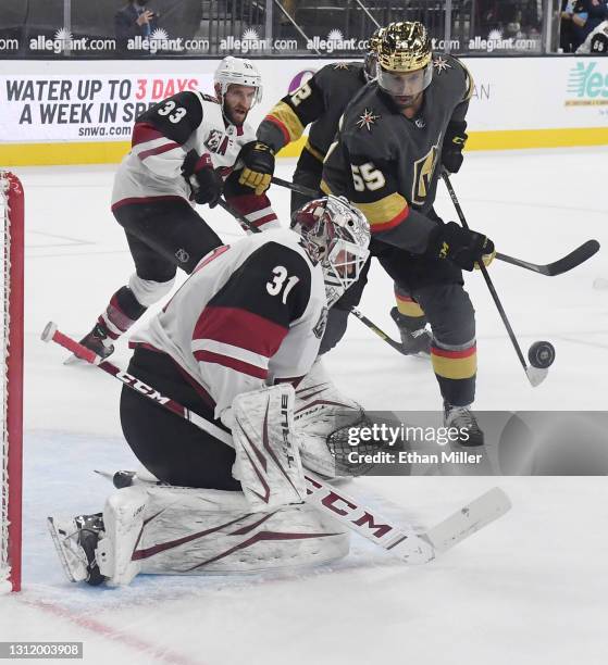 Adin Hill of the Arizona Coyotes defends the net against Keegan Kolesar of the Vegas Golden Knights in the first period of their game at T-Mobile...