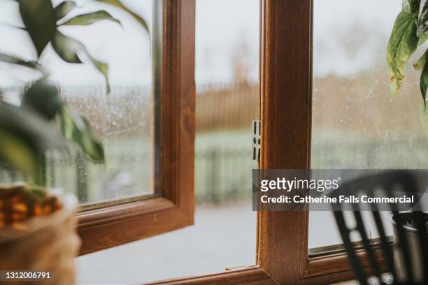 a slightly ajar window - window frame foto e immagini stock