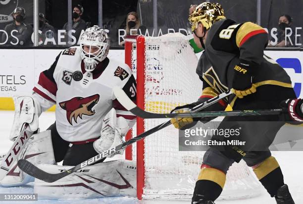 Adin Hill of the Arizona Coyotes makes a save against Jonathan Marchessault of the Vegas Golden Knights in the second period of their game at...