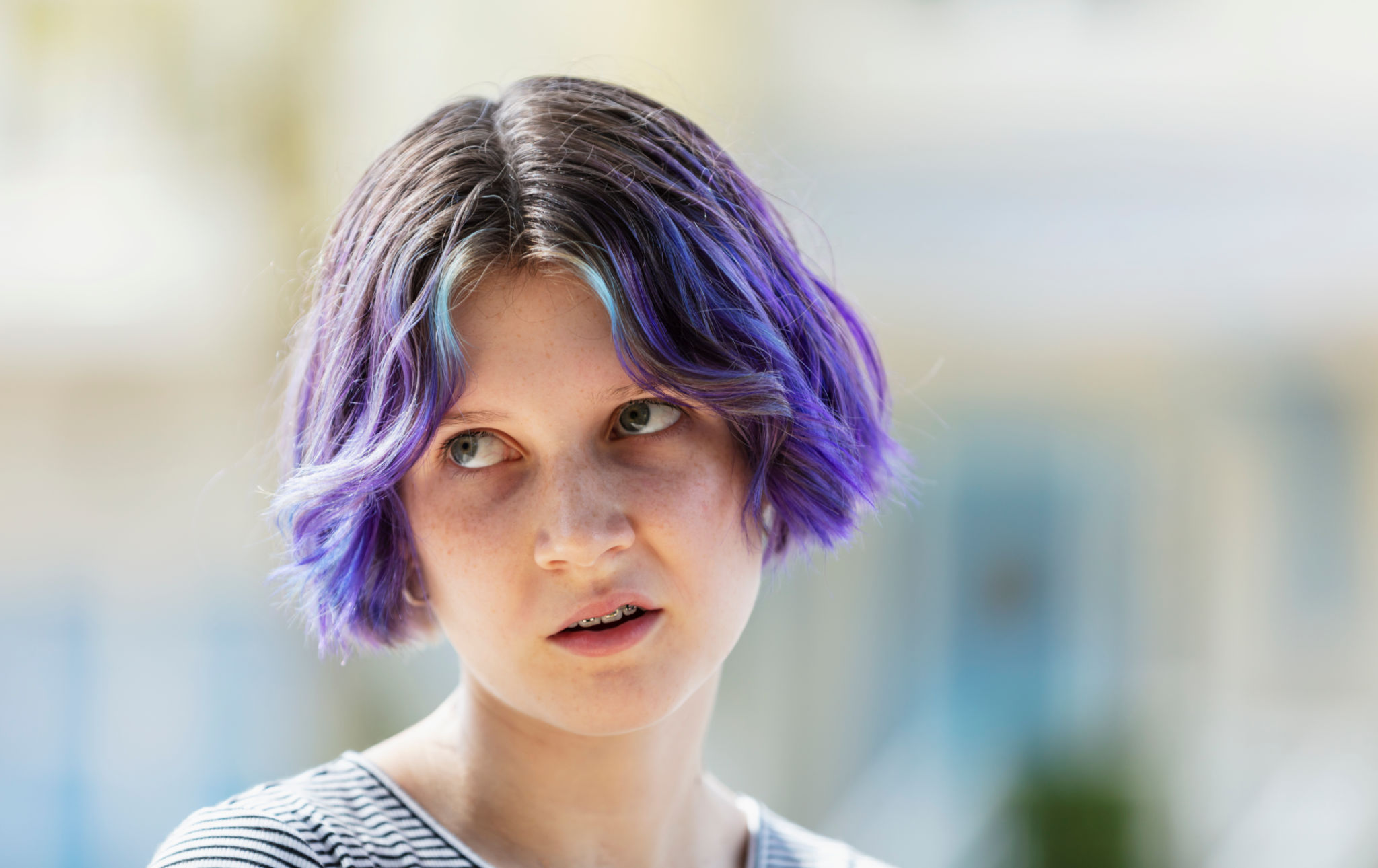 Teenage girl with purple hair rolling her eyes Teenage girl with purple hair rolling her eyes