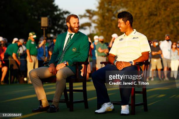 Hideki Matsuyama of Japan laughs with Dustin Johnson of the United States during the Green Jacket Ceremony after Matsuyama won the Masters at Augusta...