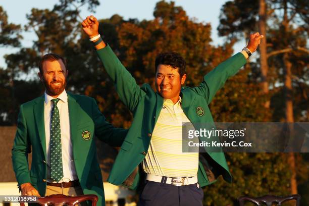 Hideki Matsuyama of Japan celebrates as 2020 Masters champion Dustin Johnson of the United States places the green jacket on him after winning the...