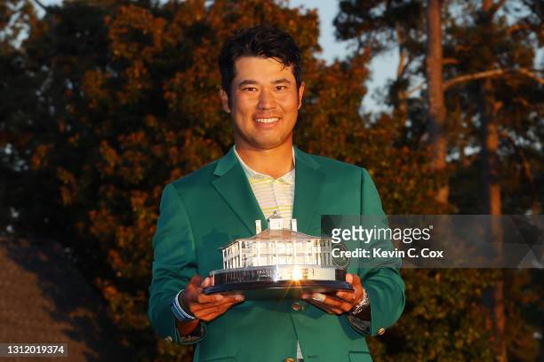 Hideki Matsuyama of Japan poses with the Masters Trophy during the Green Jacket Ceremony after winning the Masters at Augusta National Golf Club on...
