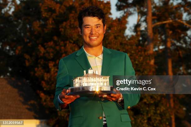 Hideki Matsuyama of Japan poses with the Masters Trophy during the Green Jacket Ceremony after winning the Masters at Augusta National Golf Club on...