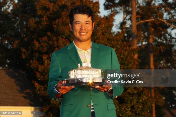 Hideki Matsuyama of Japan poses with the Masters Trophy during the Green Jacket Ceremony after winning the Masters at Augusta National Golf Club on...